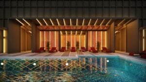 Rooftop pool lounge deck at Phoeniz Suites @ KLCC with poolside seating and illuminated leisure area.